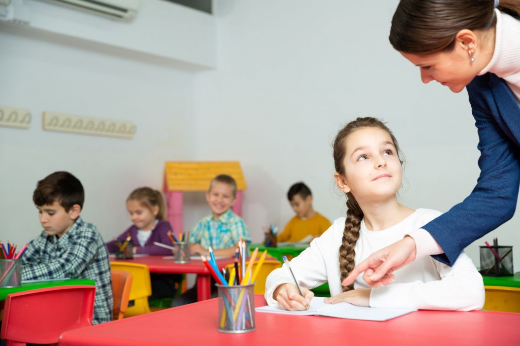 Teacher giving feedback to student (smaller size)