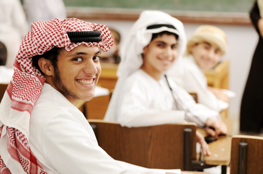Group of Arabic students with eastern traditional clothes in classroom.