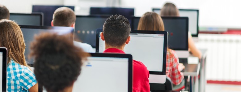 Rear view of group of people in a computer lab.