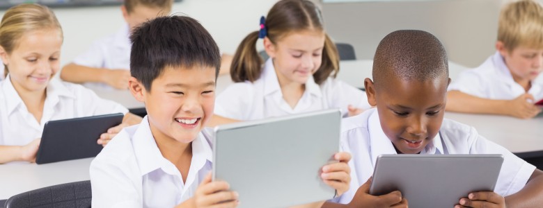 School kids using digital tablet in classroom