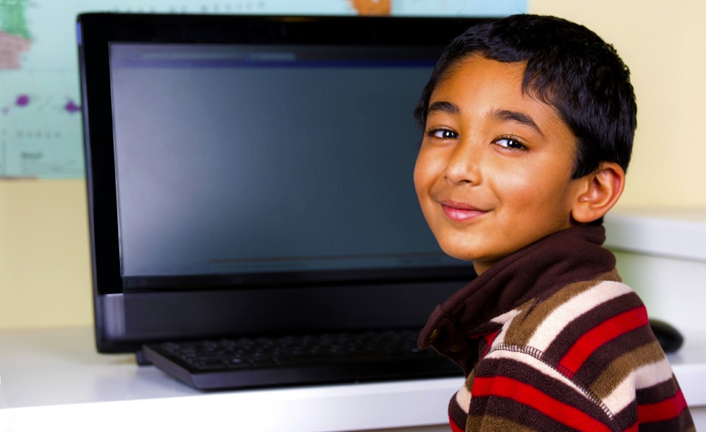 Little Boy Working On a Computer At His Desk